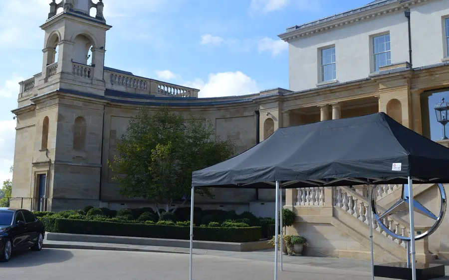 A black 6x3m pro gazebo set up for a brand event outside a country house