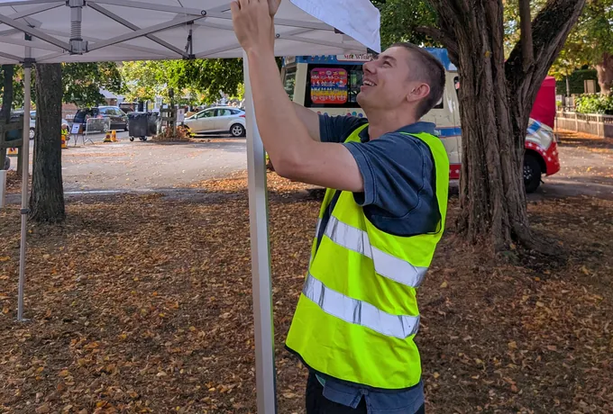 Henry building a gazebo at a village event in Beaconsfield