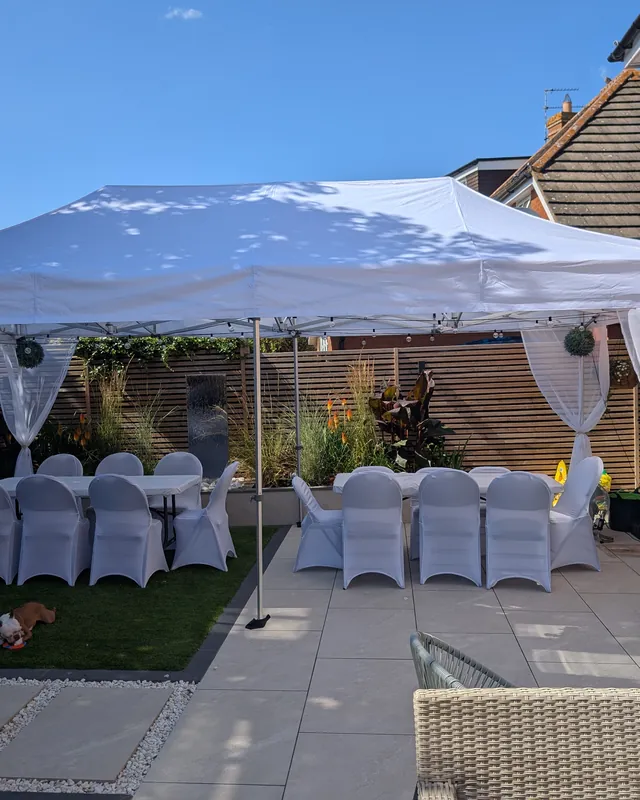 The 8x4m Estate set up across a lawn and patio for a garden party