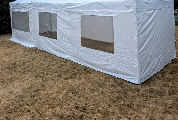 Two linked 6x3m gazebos with full sides and window panels