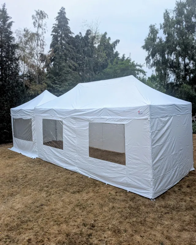 Two linked 6x3m gazebos with full sides and window panels, built on site
